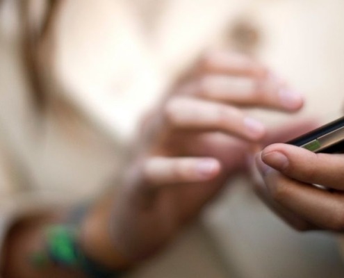 Blurred image of woman's hands holding smartphone