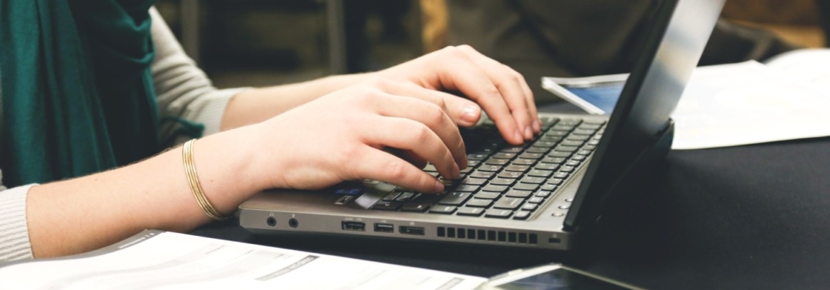 Women's hands on laptop keyboard