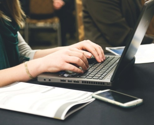 Women's hands on laptop keyboard