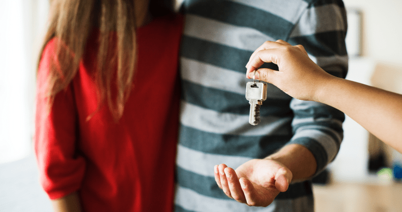 Young couple receiving house keys