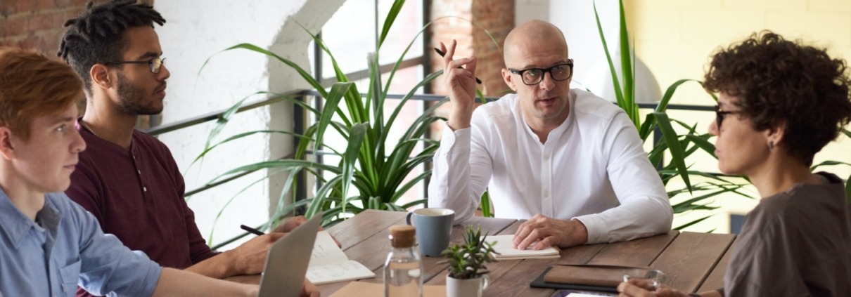 Four people having a meeting