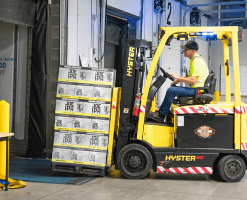 Young man driving forklift