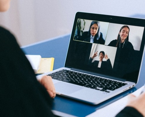 Screen of online meeting with three women