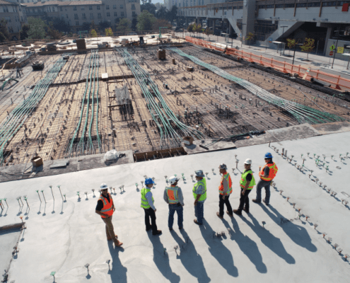 Group of construction workers overseeing building site
