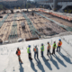 Group of construction workers overseeing building site