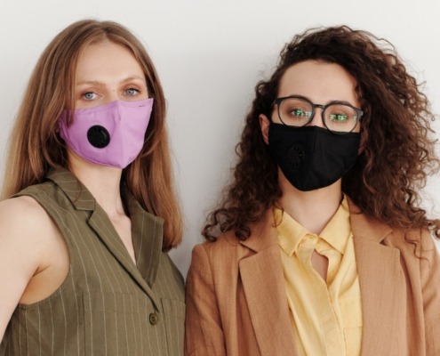 Two women wearing masks